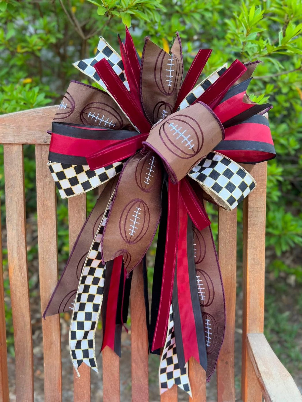 Football-print bow in brown, maroon, and black-and-white check ribbon